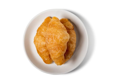 Fresh croissant on plate with clipping path isolated on a white background.