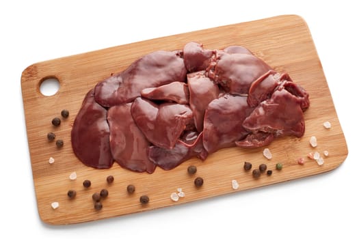 Fresh raw chicken livers on  on a wooden cutting board on white background.
