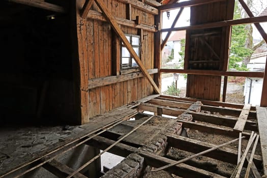 An old wooden house with a broken floor. A house is being torn down