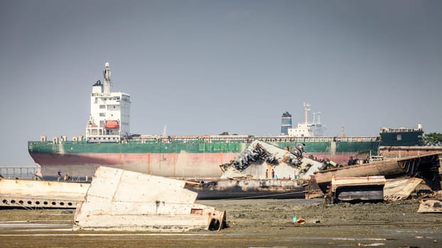 Chittagong, Bangladesh, December 23, 2017: Old ships are being dismantled at ship-breaking yards in Chittagong, Bangladesh