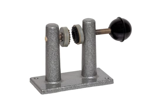 Close-up of an old clamp device that was used to frame film strips between two glasses. Entertainment last century to look holiday pictures on a projection screen. Macro isolated on white.