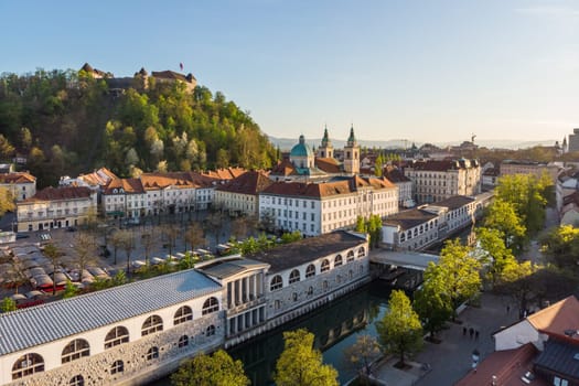 Aerial drone panoramic view of Ljubljana medieval city center, capital of Slovenia in warm afternoon sun. Empty streets during corona virus pandemic social distancing measures.