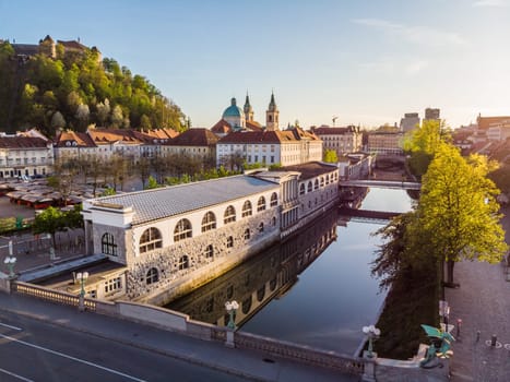 Aerial drone panoramic view of Ljubljana medieval city center, capital of Slovenia in warm afternoon sun. Empty streets during corona virus pandemic social distancing measures.