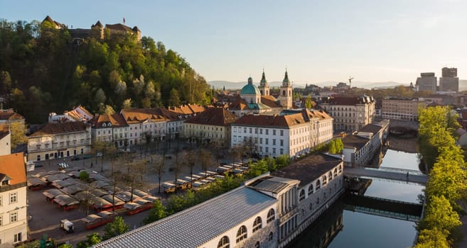 Aerial drone panoramic view of Ljubljana medieval city center, capital of Slovenia in warm afternoon sun. Empty streets during corona virus pandemic social distancing measures.