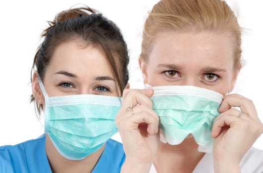 a portrait of two young nurses with a mask