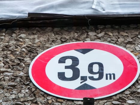 Close-up of the German traffic sign number 265, in order to ban vehicles above the specified actual height above a Berlin gate entrance.