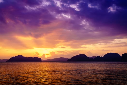 Scenic sunset in Andaman Sea in Thailand with Phuket coastline in the backdrop