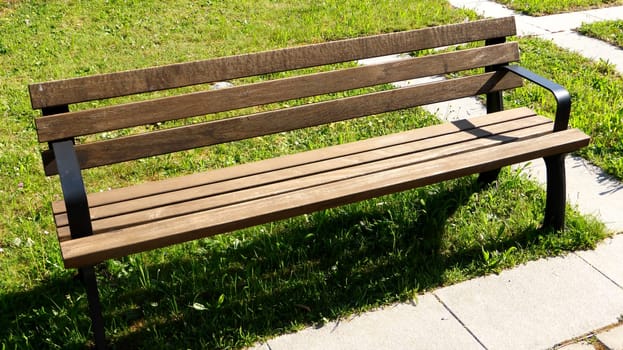 empty park bench with sun and shadow
