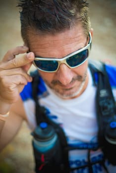 Photography session of trail runner runnig in the middle of nature and in the mountains. Preparing and interviewing