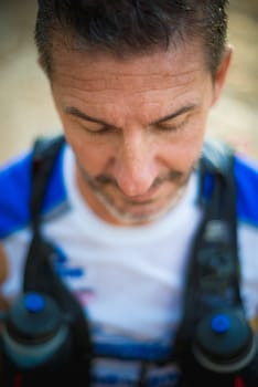 Photography session of trail runner runnig in the middle of nature and in the mountains. Preparing and interviewing