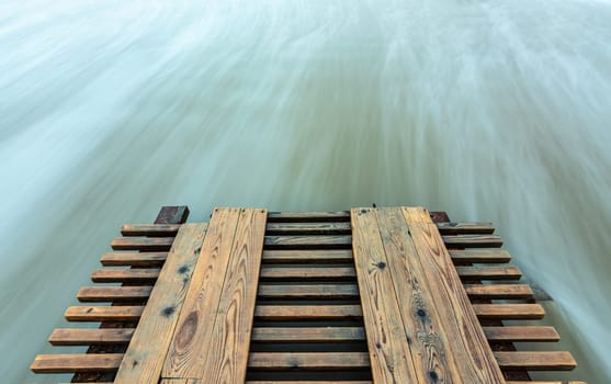 Broken pier and surf washed out with long exposure