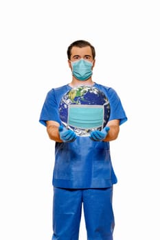 Male doctor in scrubs with face mask supporting planet earth with protective face mask. Plain white background. Coronavirus concept, 3D illustration