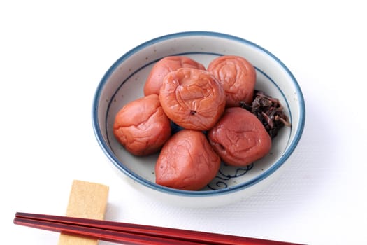 Japanese food, salted Umeboshi in a dish on white background