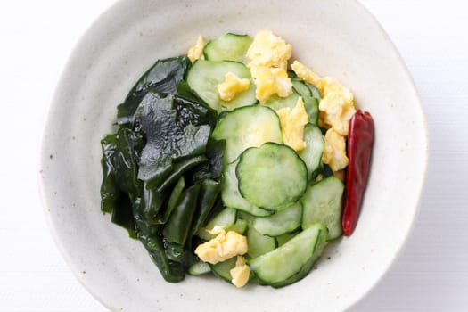 Japanese sunomono food, vinegared cucumber with seaweed wakame in a dish