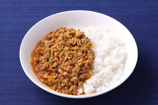 Close up of Japanese keema curry rice with spoon on table