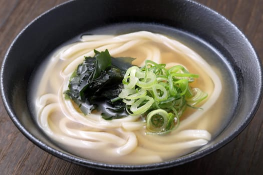 Japanese curry udon noodles in a ceramic bowl on table