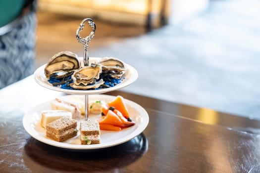 Welcome cocktail Canapes dish, Fresh Oyster and smoked salmon seafood dish. Appetizer dish before groumet brunch buffet international cuisine.