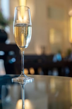 Glass of sparkling champagne on wooden table