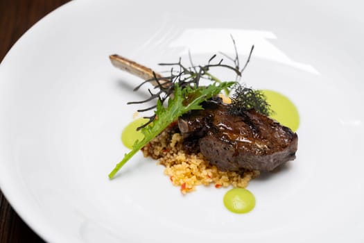 Grilled lamb chop with pesto sauce, international gourmet cuisine a la carte in buffet live station. Using for food and drink industry.
