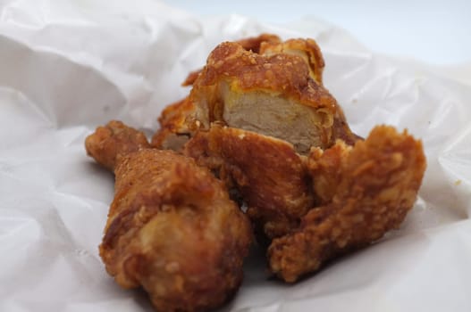 Hot and crispy fried chicken on white paper