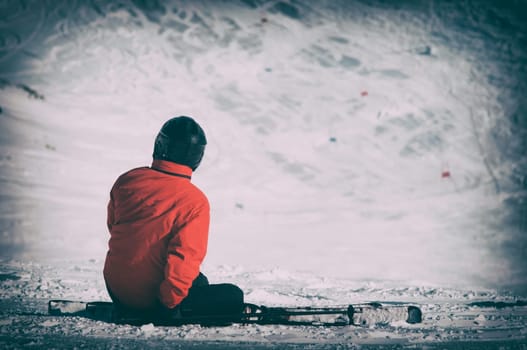 skier sitting on a downhill