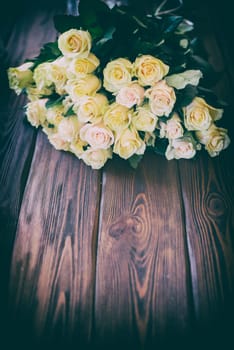 orange roses on wooden background,vintage