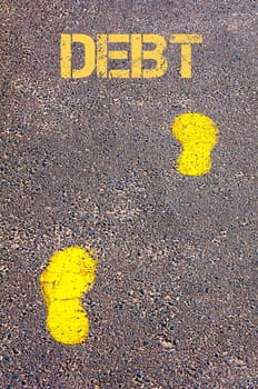 Yellow footsteps on sidewalk towards Debt message, Business conceptual image