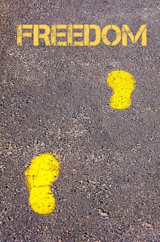 Yellow footsteps on sidewalk towards Freedom message, Independence conceptual image