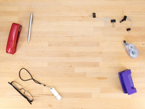 Stationery and work objects on a wooden  office desk