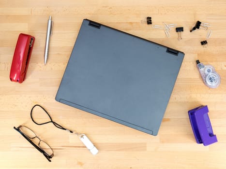 Stationery and work objects on a wooden  office desk