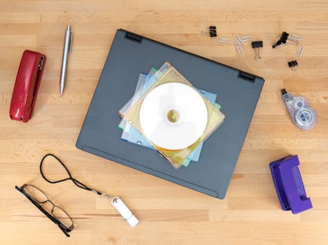 Stationery and work objects on a wooden  office desk