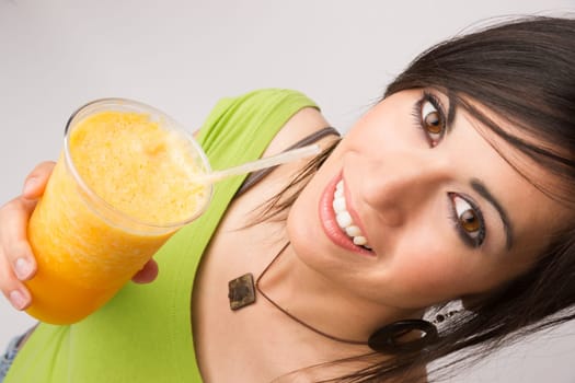 A beautiful woman enjoys a smoothie during a detox cleanse