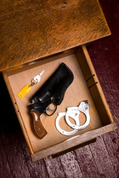 Dark Office and 38 Revolver in Desk Drawer with Handcuffs