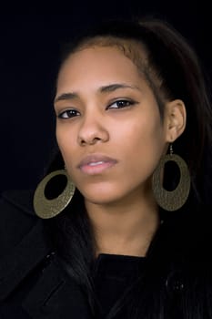 young beautiful woman close up portrait, on black background