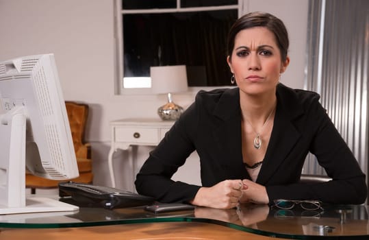 Woman at computer desks looks frustrated