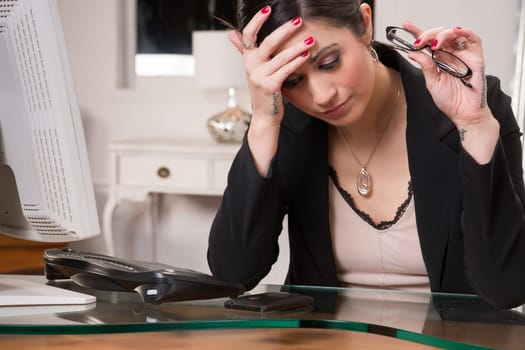 Woman at computer desks looks frustrated