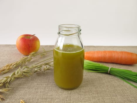 Green smoothie with oat grass,carrot and apple