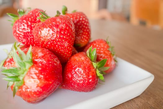 Fresh ripe strawberries on white plate, stock photo
