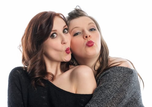 Two girlfriends hug each other and make kiss mouth