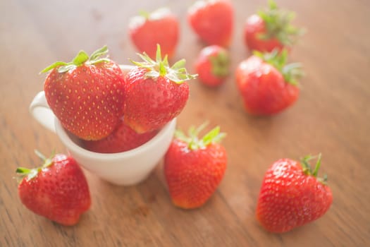 Fresh ripe strawberries on wooden background, stock photo