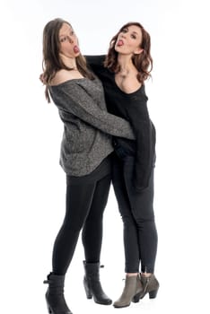 Two girlfriends stretch out their tongues