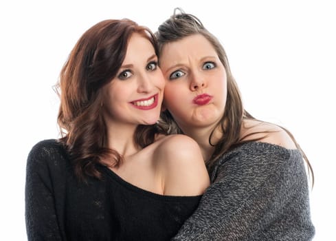 2 girlfriends hug each other and silly around