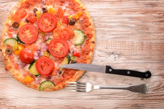 Vegetarian pizza on a wooden table