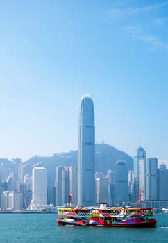 A ferry in Hong Kong harbour with the city skyline in the background