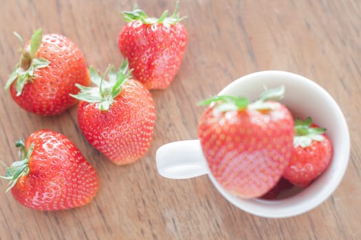 Fresh strawberries on wooden table, stock photo
