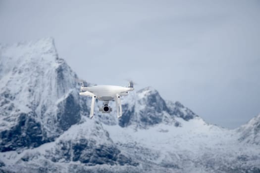 Quadcopter drone with digital camera in mountains