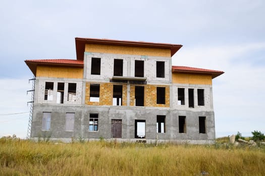 Houses under construction in the suburbs. Construction of new houses and buildings.