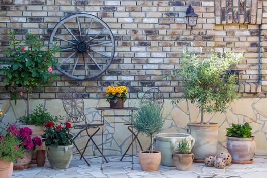 beautiful place in the garden in the mediterranean style, brick wall with grill and pots with flowers