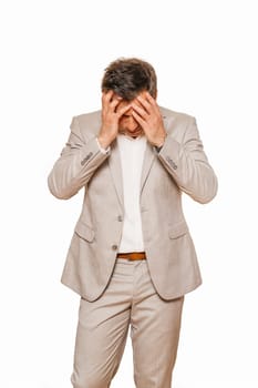 Middle age businessman in beige suite, broken and depressed as his business falling during recession of coronavirus, isolated on white background
