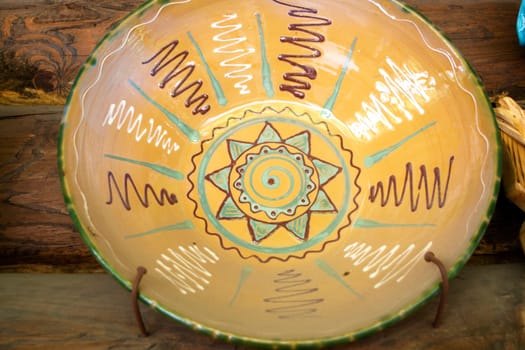 Authentic ceramic dish of Belarus with traditional pattern, on rustic wooden background